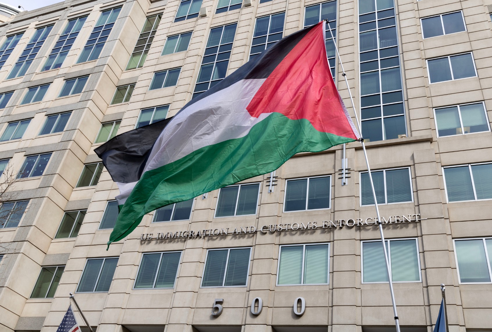 Demonstrators wave a Palestinian flag outside the U.S. Immigration and Customs Enforcement building during the 'Fight for Our Rights' protest in Washington, DC. (Probal Rashid/LightRocket via Getty Images)