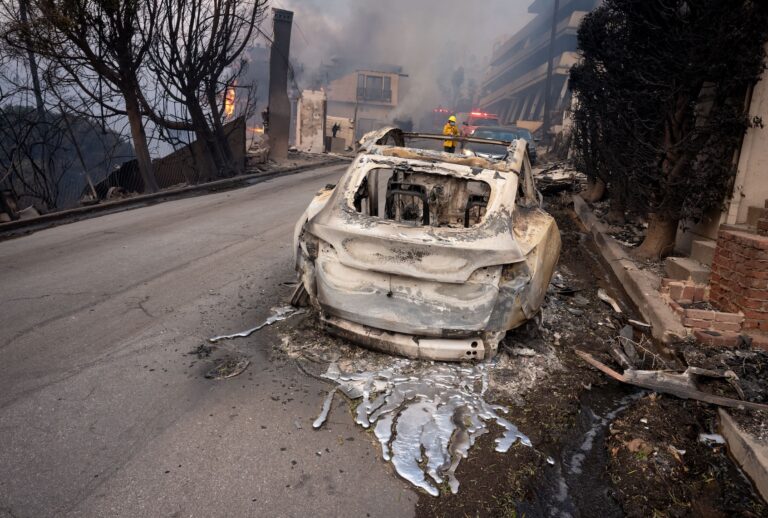 MALIBU, CA - January 08: A Tesla is melted into the street above Pacific Coast Highway in Malibu, CA on Wednesday, January 8, 2025. High winds escalated the spread of several blazes across Southern California. (Photo by David Crane/MediaNews Group/Los Angeles Daily News via Getty Images)