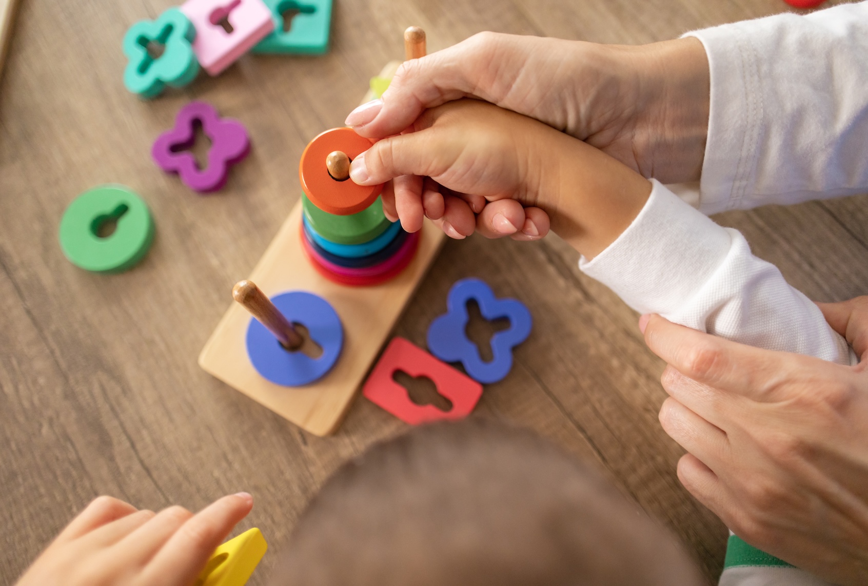 A dedicated female nurse supports a young autistic boy using sensory toys to enhance motor abilities. (Getty Images / Dusan Stankovic)