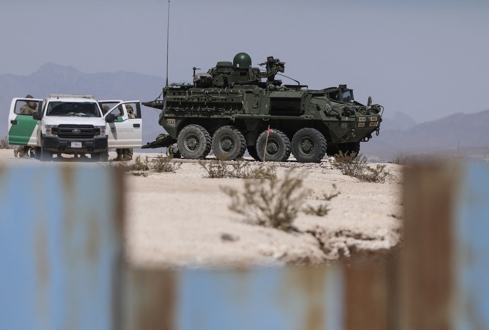 U.S. Border Patrol agents and an eight-wheeled Stryker armored vehicle patrolling the border area in Sunland Park, New Mexico state, U.S., are seen from Ciudad Juarez, Chihuahua state, Mexico on March 28, 2025. (Photo by HERIKA MARTINEZ/AFP via Getty Images)