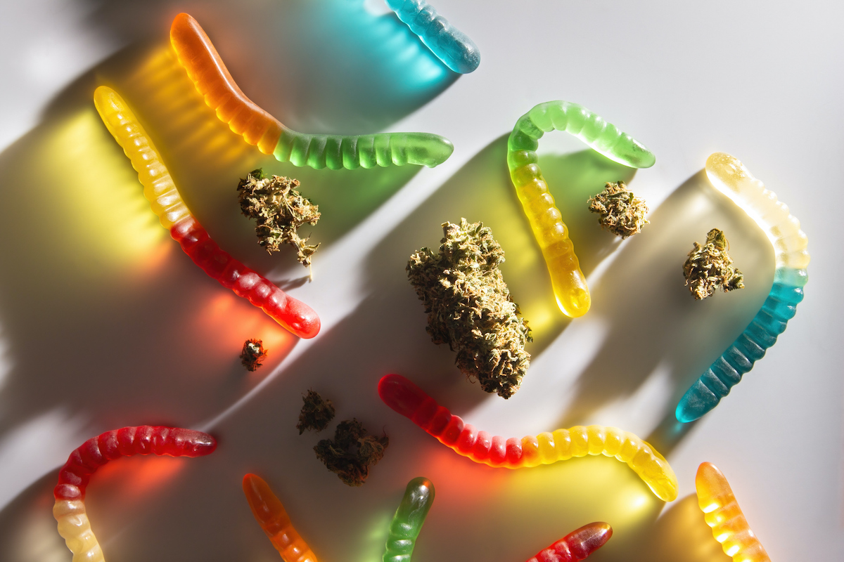 Dried cannabis buds and gummy worms (Getty Images / Nyaaka Photo)