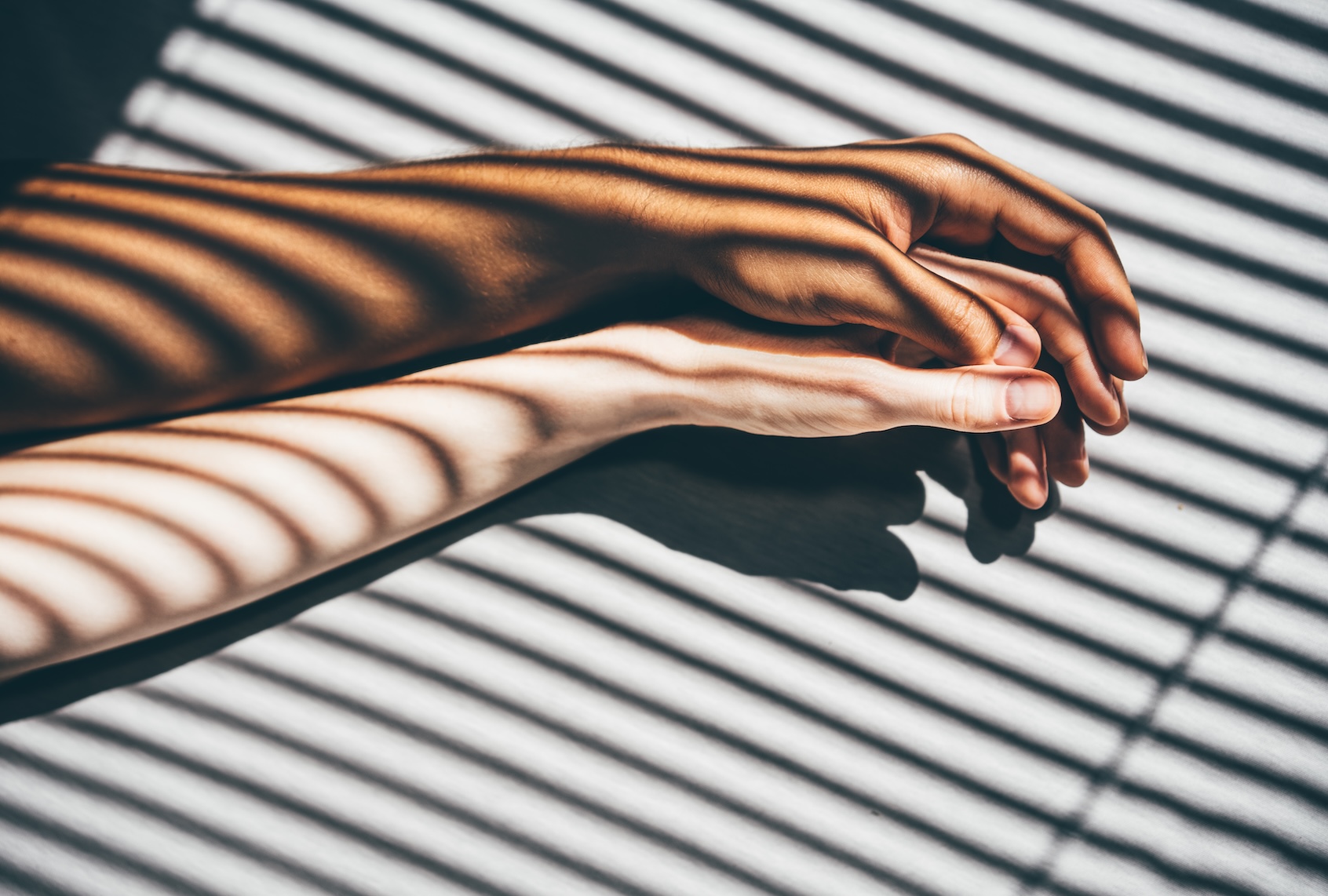 Couple holding hands on the bed. (Getty Images / Maria Korneeva)