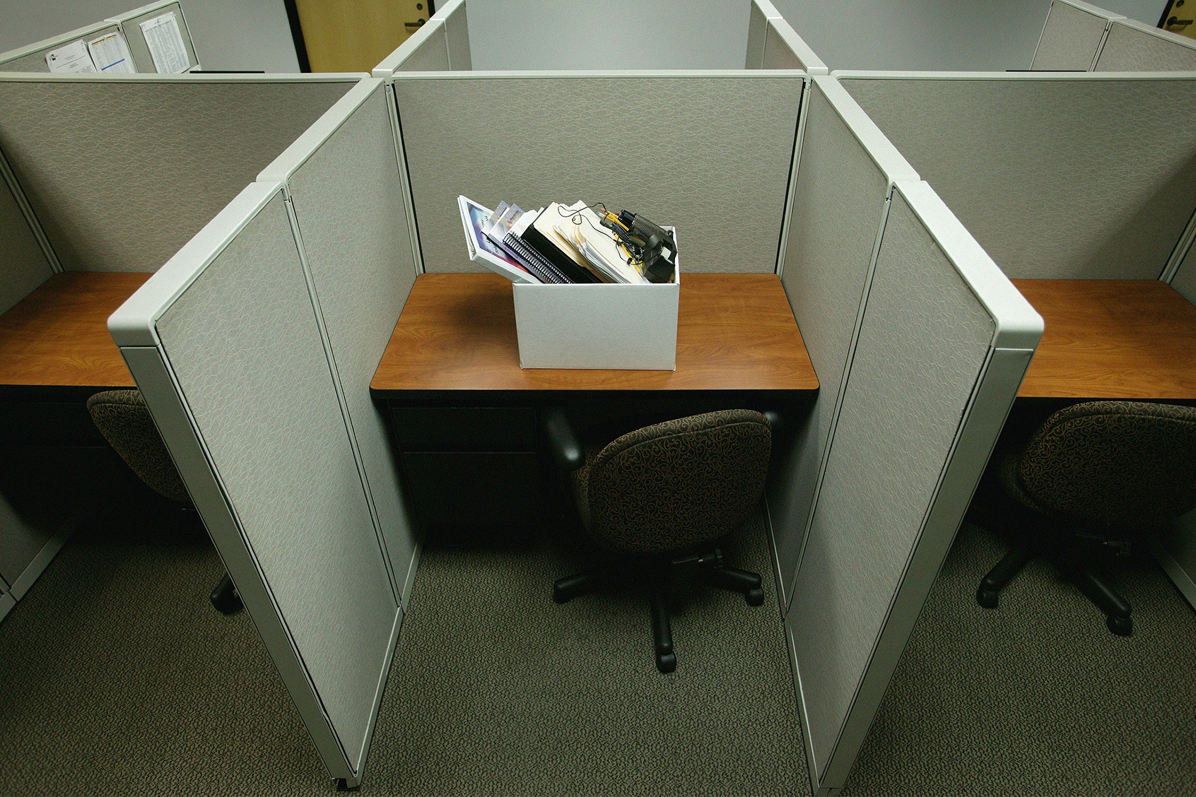 Cubicle with box of personal belongings (Getty Images/Bill Varie)