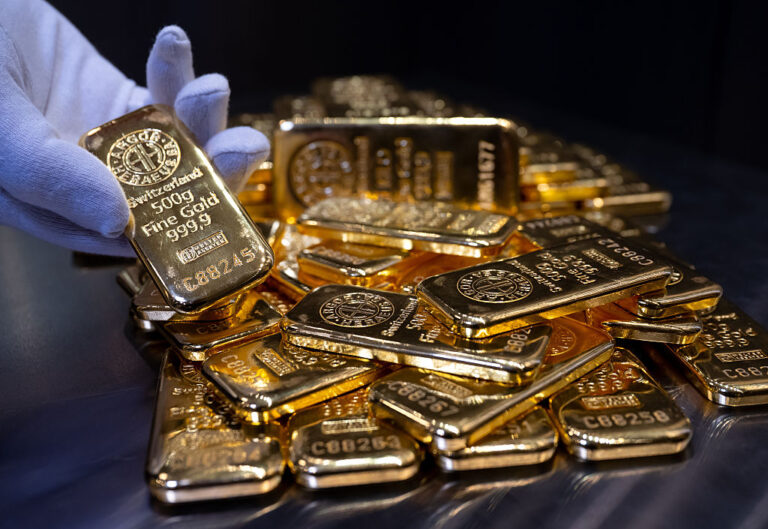 Gold bars of various sizes lie in a safe on a table at the precious metal dealer Pro Aurum. (Photo by Sven Hoppe/picture alliance via Getty Images)