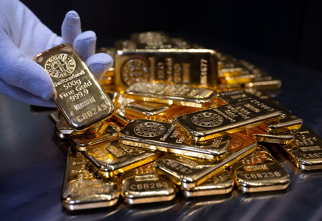 Gold bars of various sizes lie in a safe on a table at the precious metal dealer Pro Aurum. (Photo by Sven Hoppe/picture alliance via Getty Images)