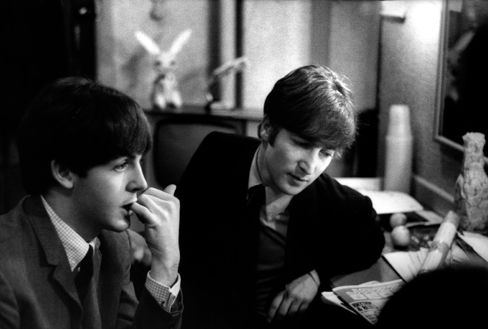 Paul McCartney and John Lennon backstage at the Finsbury Park Astoria, London, during the band's Christmas Show residency on December 30, 1963. (Val Wilmer/Redferns)