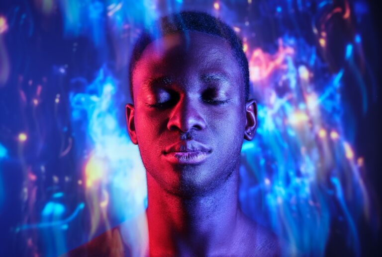 Man with eyes closed standing in blurred light. (Addictive Stock / Getty Images)