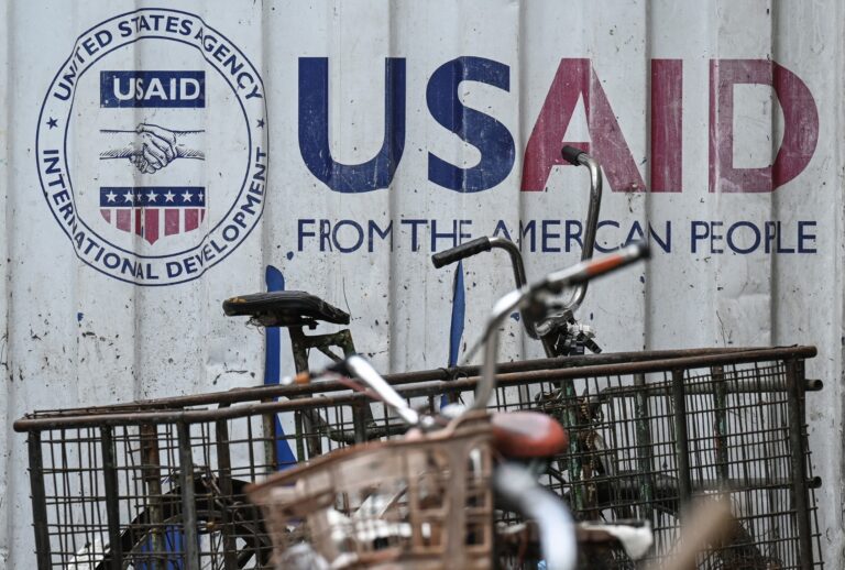 Signage for the US government's humanitarian agency USAID is seen on a cargo container beside a tricycle in Manila on February 4, 2025. (JAM STA ROSA/AFP via Getty Images)