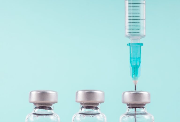 Row of medical vials and syringe. (A. Martin UW Photography / Getty Images)