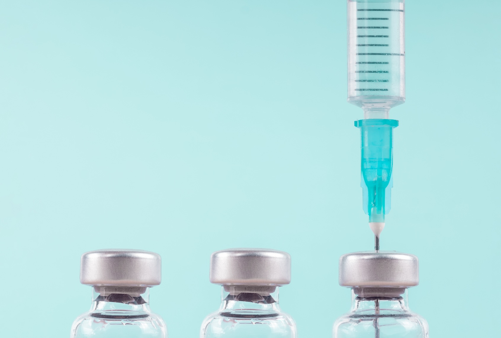 Row of medical vials and syringe. (A. Martin UW Photography / Getty Images)