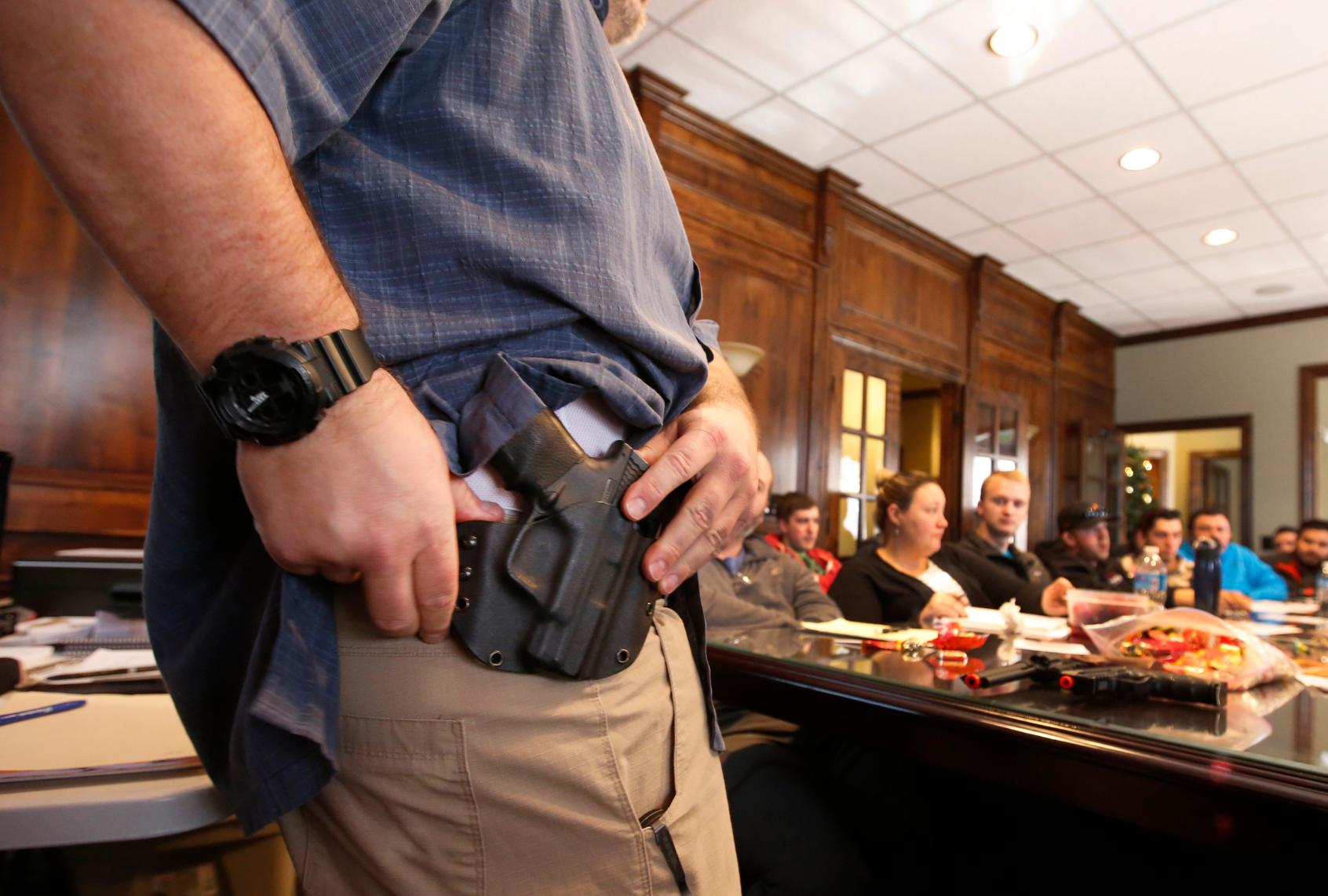 Damon Thueson shows a holster at a gun concealed carry permit class put on by "USA Firearms Training" on December 19, 2015 in Provo, Utah.
Uptick In Interest In Concealed Carry Classes (George Frey/Getty Images)
