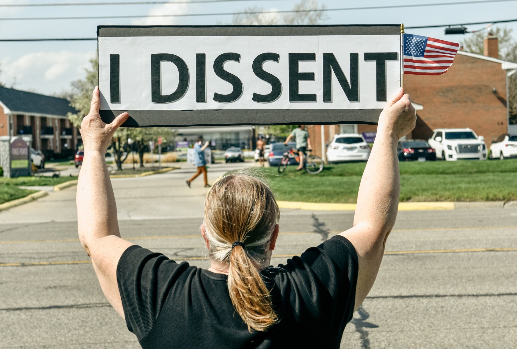 A protestor holds up a sign saying "I Dissent" alongside approximately 3,000 other protestors showing their displeasure for President Trump's policies outside of Macomb Community College in Warren, Michigan on April 29, 2025. (Adam J. Dewey/Anadolu via Getty Images)