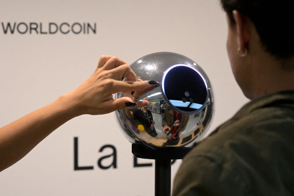 A man has his iris scanned with an orb, a biometric data scanning device, in exchange for the Worldcoin cryptocurrency in Buenos Aires on March 22, 2024. (Getty Images/Juan Mabromata)