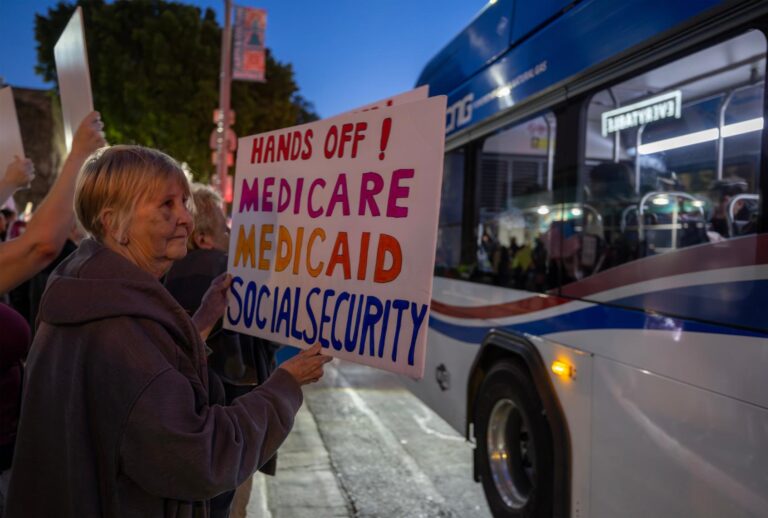 A woman holds a sign expressing fear of cuts to Medicare, Medicaid and Social Security, at a "Hands Off!" protest against the Trump administration on April 5, 2025 in Riverside, California. (David McNew/Getty Images)