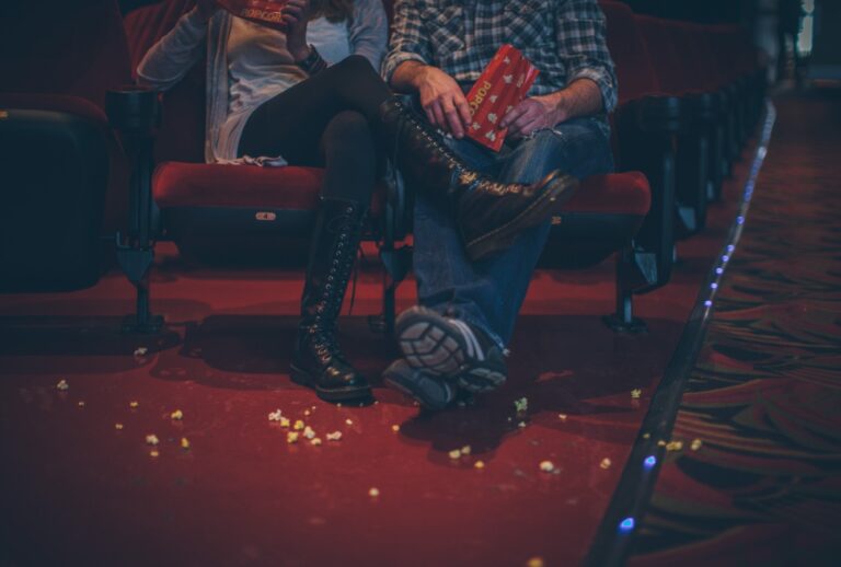 Couple with popcorn on the floor at the movie theater. (EVOK/R.Lauren/Getty)