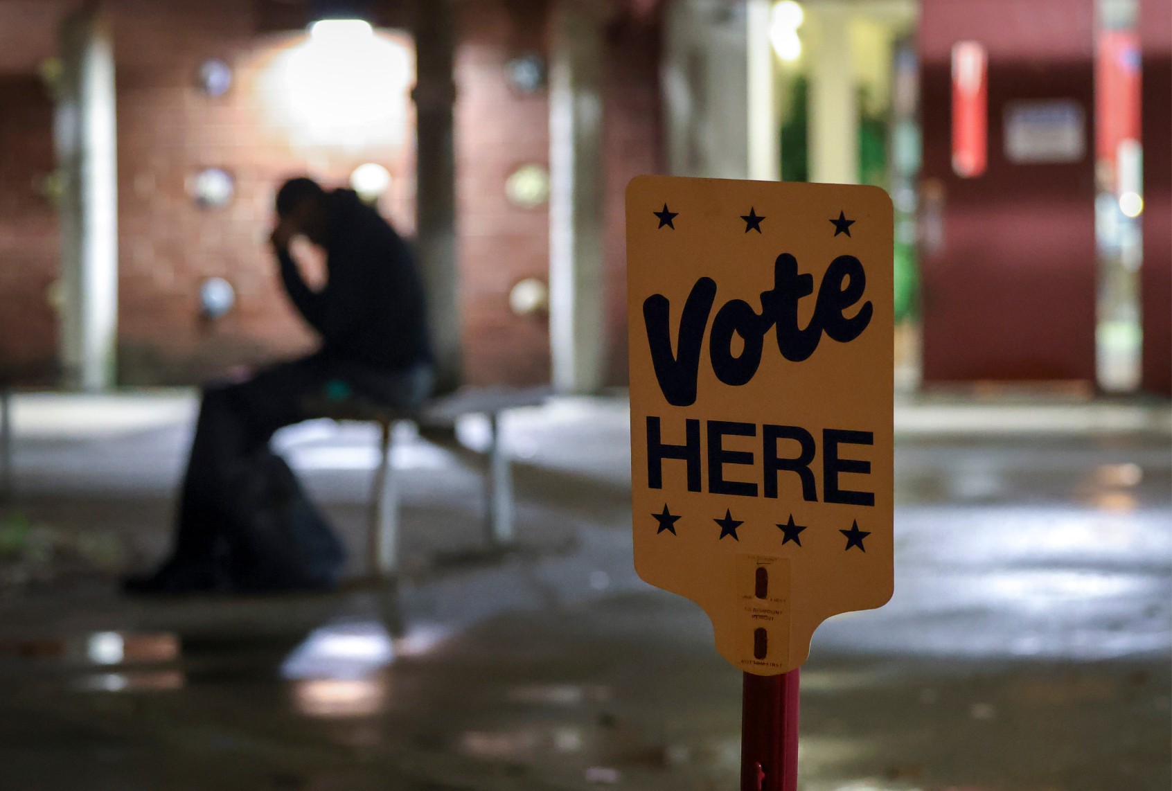 A man sits outside of Precinct 13 near uptown before the polls open on Election Day 2024 in Charlotte, North Carolina on Tuesday, November 5, 2024. (Logan Cyrus for The Washington Post via Getty Images)