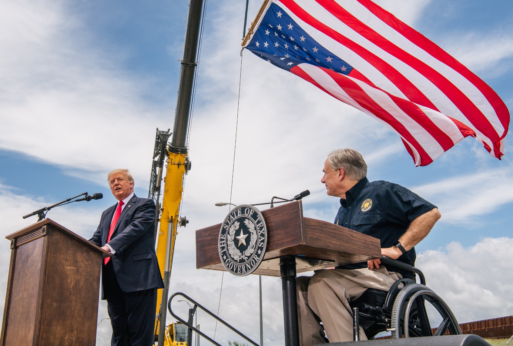 Texas Gov. Greg Abbott listens to President Donald Trump's address during a tour to an unfinished section of the border wall on June 30, 2021 in Pharr, Texas. (Brandon Bell/Getty Images)