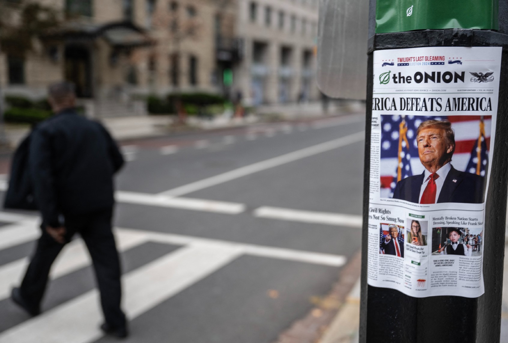 A copy of "The Onion," a satirical newspaper, is seen on a lamppost in downtown Washington, DC on November 14, 2024. (ANDREW CABALLERO-REYNOLDS/AFP via Getty Images)