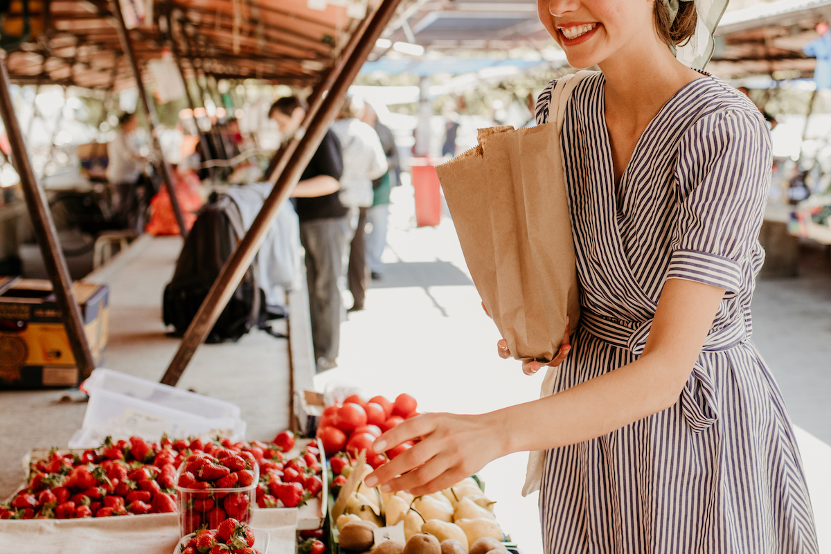 A "tomato girl" at the market (Studio4/Getty Images )