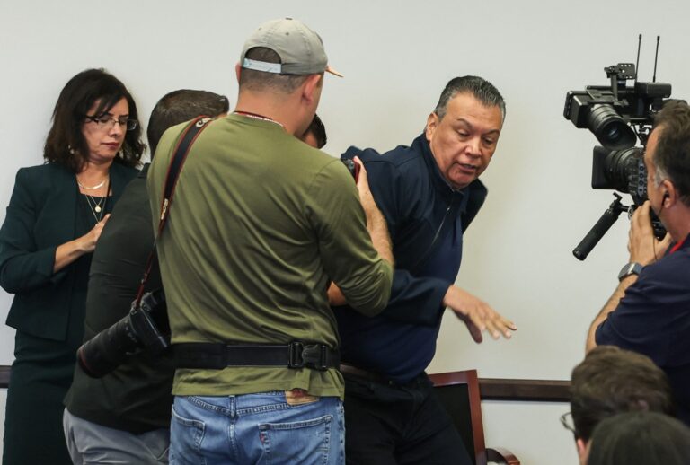 Senator Alex Padilla, Democrat from California, is removed from the room after interrupting a news conference with Department of Homeland Security Secretary Kristi Noem at the Wilshire Federal Building in Los Angeles on June 12, 2025. (PATRICK T. FALLON/AFP via Getty Images)