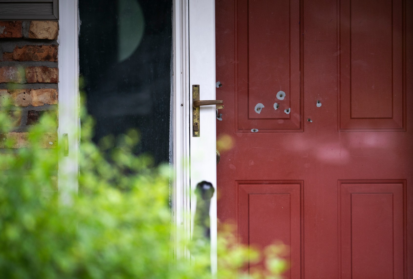 Bullet holes are seen in the door outside the home of DFL State Sen. John Hoffman on June 15, 2025 in Champlin, Minnesota. (Stephen Maturen/Getty Images)