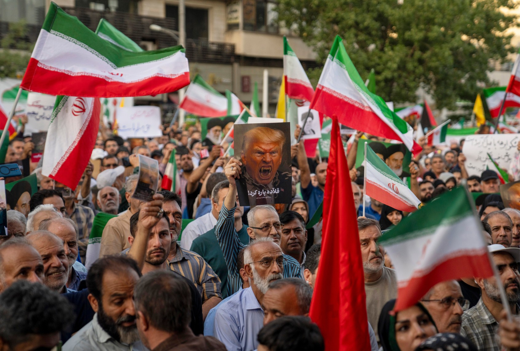Iranian protesters chant slogans and one holds a poster with a vampire-like illustration of US President Donald Trump in Revolution Square to protest US attacks on nuclear sites in Iran on June 22, 2025 in Tehran, Iran. (Getty Images)
