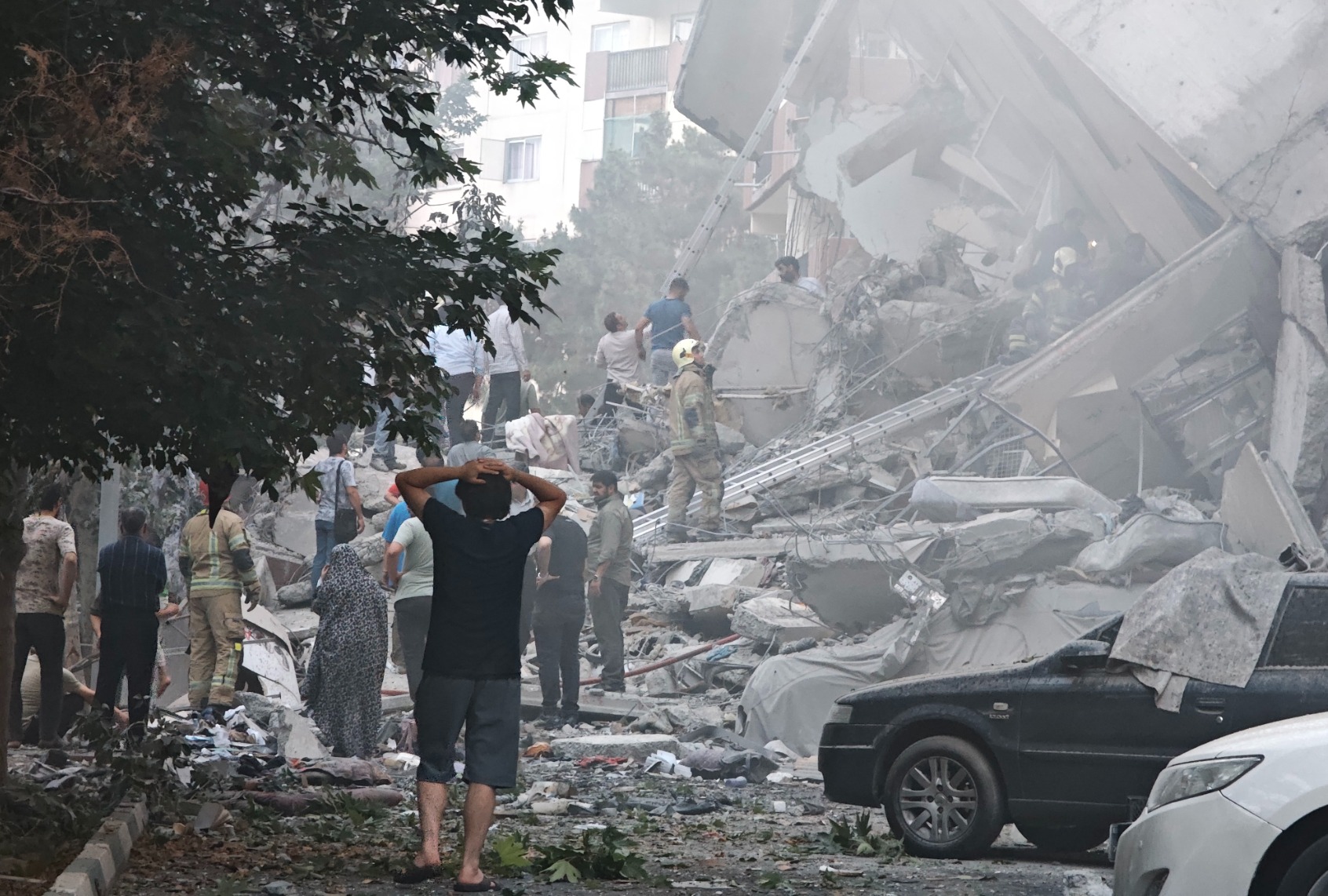 People look over damage to buildings in Nobonyad Square following Israeli airstrikes on June 13, 2025 in Tehran, Iran. Iran's three top military generals were killed in the attacks that also targeted nuclear and military facilities, according to published reports. (Majid Saeedi/Getty Images)