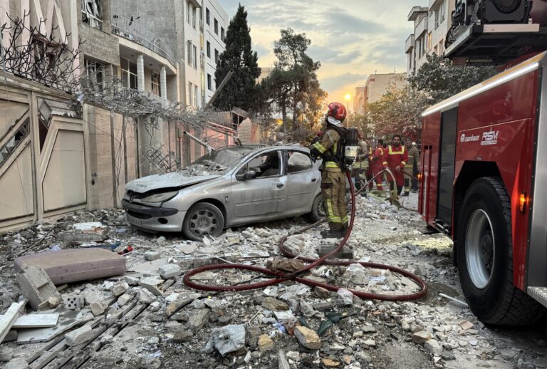 First-responders gather outside a building that was hit by an Israeli strike in Tehran on June 13, 2025. (MEGHDAD MADADI/TASNIM NEWS/AFP via Getty Images)