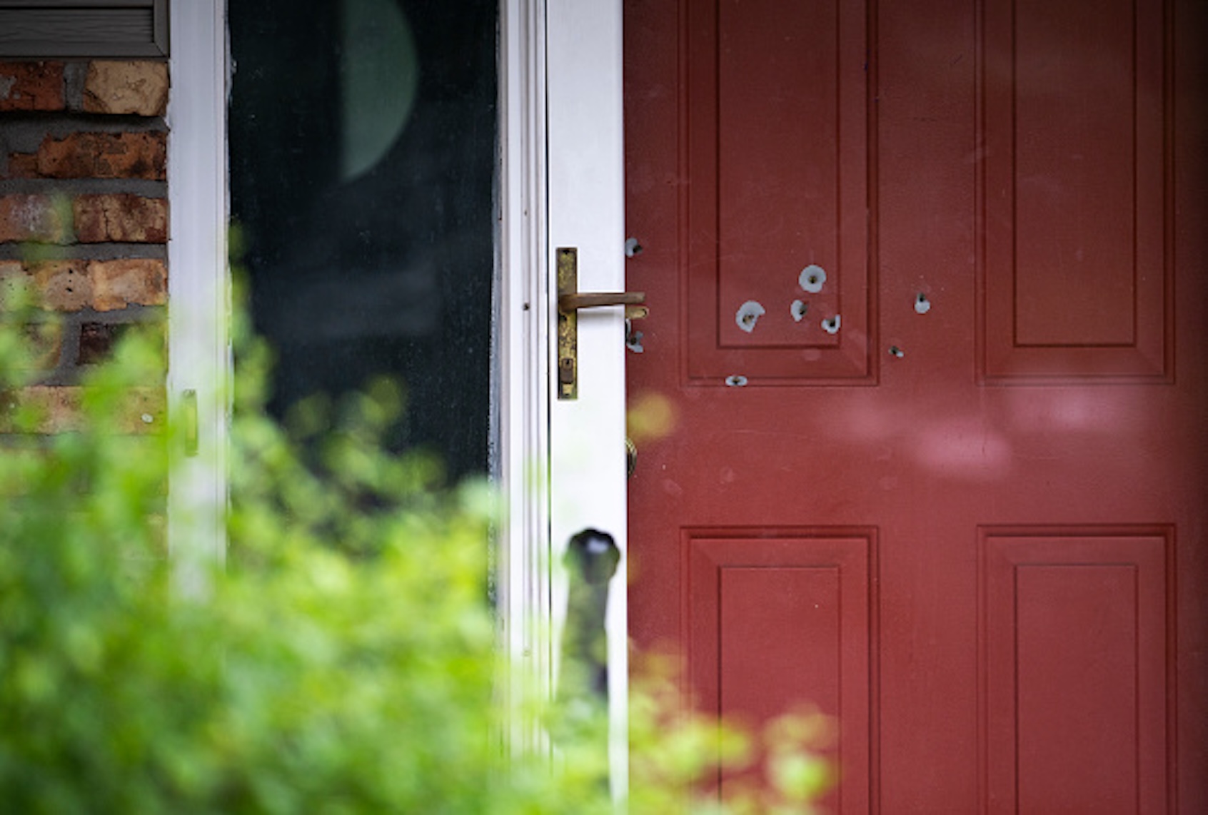 Bullet holes are seen in the door outside the home of State Sen. John Hoffman on June 15, 2025 in Champlin, Minnesota. (Stephen Maturen/Getty Images)