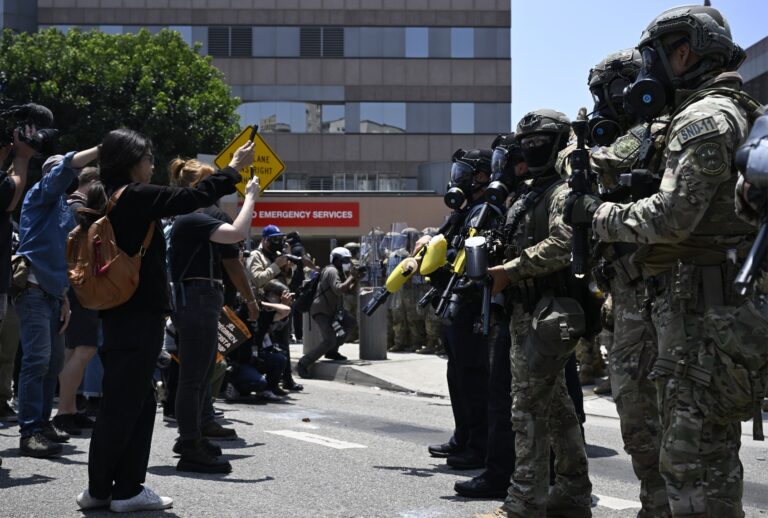 ICE officers and National Guard soldiers stand outside of the Metropolitan Detention Center in Los Angeles, California on June 8, 2025. (Tayfun Coskun/Anadolu via Getty Images)