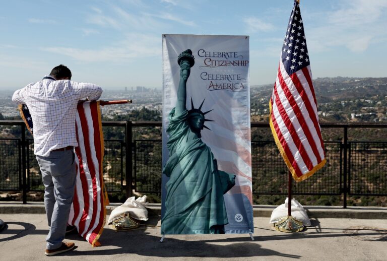 An American flag is furled following a special naturalization ceremony on the Hollywood Sign Terrace at historic Griffith Observatory on October 21, 2024 in Los Angeles, California. (Mario Tama/Getty Images)