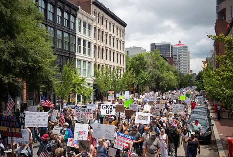 Protesters march during a nationwide "No Kings" rally in downtown Louisville, Kentucky, on June 14, 2025, on the same day as President Donald Trump's military parade in Washington, DC. Thousands of people rallied across the United States on June 14 as a so-called "No Kings" has sprung up against the policies of US President Donald Trump, ahead of a rare military parade on his 79th birthday. (LEANDRO LOZADA/AFP via Getty Images)