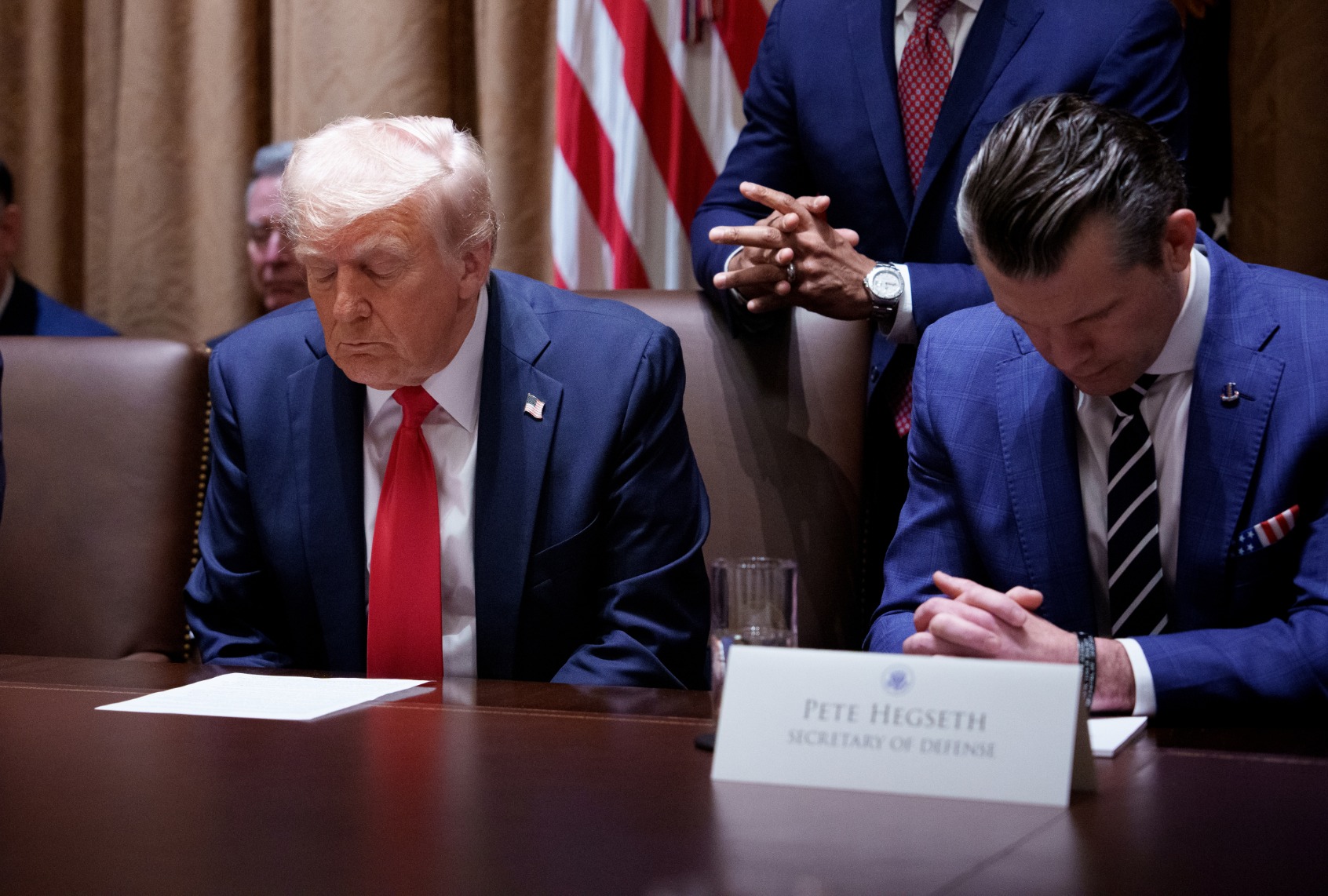 President Donald Trump and Defense Secretary Pete Hegseth pray during a Cabinet meeting at the White House on February 26, 2025 in Washington, DC. (Andrew Harnik/Getty Images)