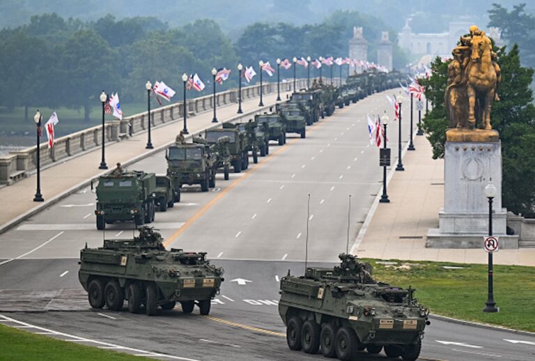 Members of the U.S. Army and armored vehicles move across the Memorial Bridge during the Army 250th Anniversary Parade in Washington, D.C., on June 14, 2025. President Donald Trump reveled in a long dreamt-of military parade on his 79th birthday Saturday, as demonstrators across the country branded him a dictator in the biggest protests since his return to power. (ANNABELLE GORDON/AFP via Getty Images)