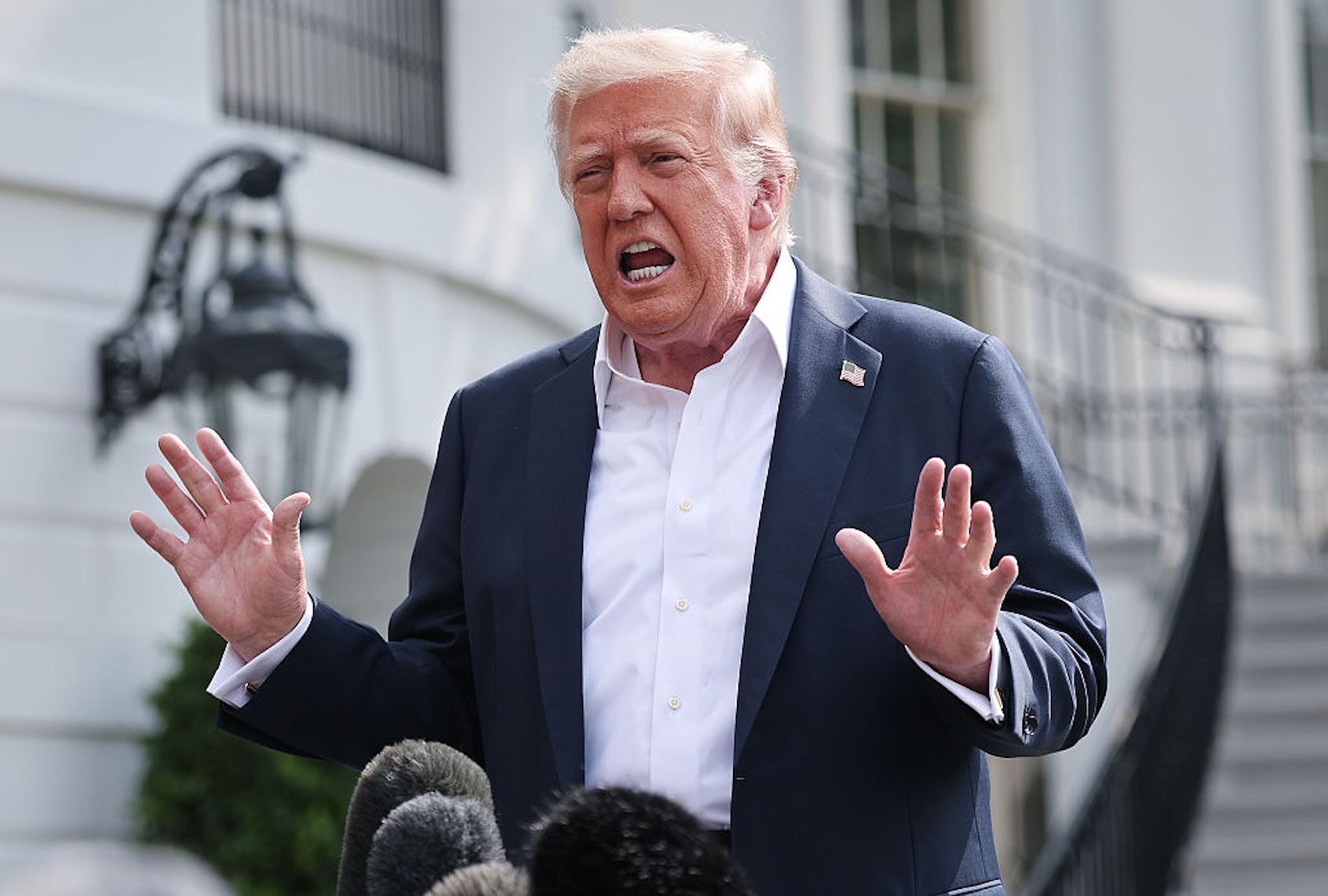 President Donald Trump answers questions while departing the White House on July 11, 2025. (Win McNamee/Getty Images)