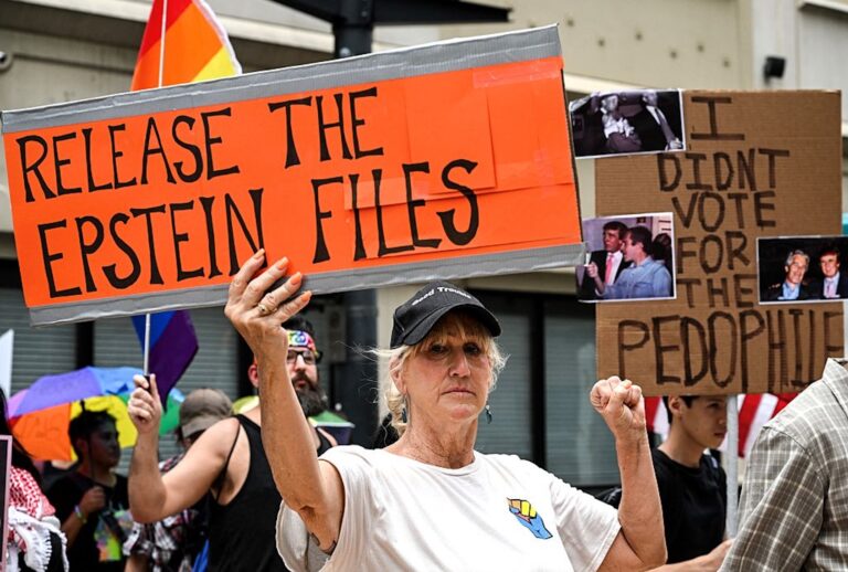 People holds signs calling for the release of Justice Department files regarding late sex offender Jeffrey Epstein. (RONALDO SCHEMIDT/AFP via Getty Images)