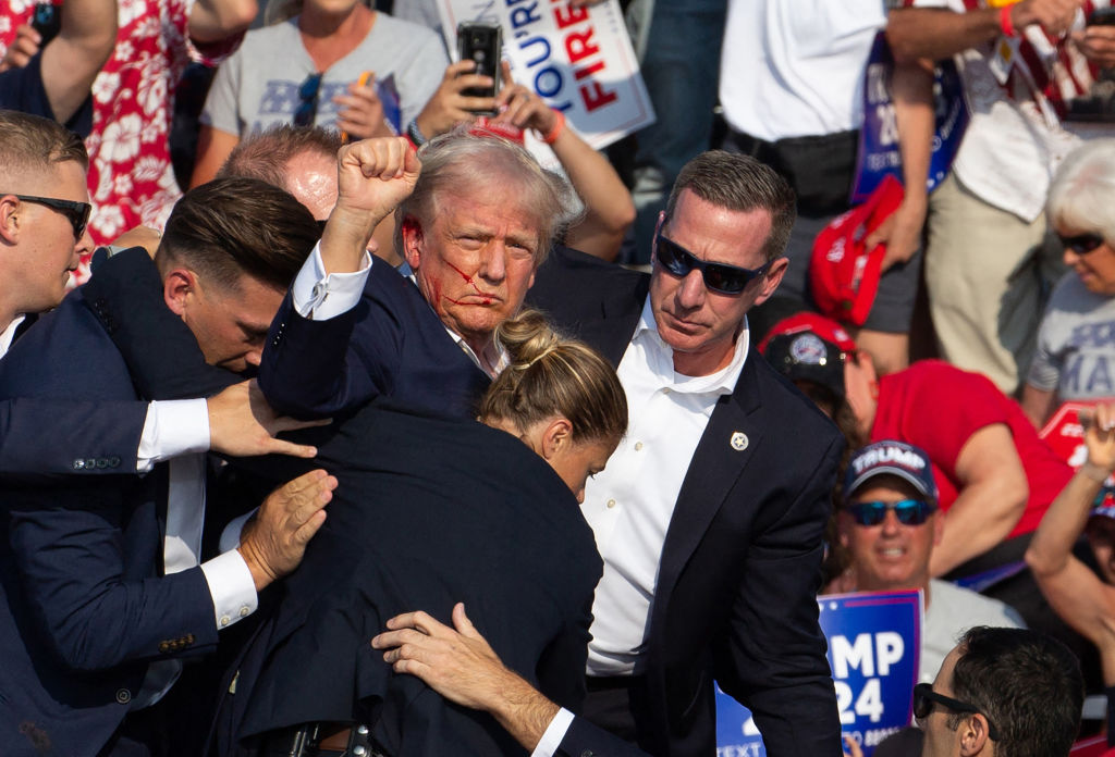 MAGA faithful celebrate the one year anniversary of Trump's assassination attempt as "divine intervention." (REBECCA DROKE / AFP / Getty Images)