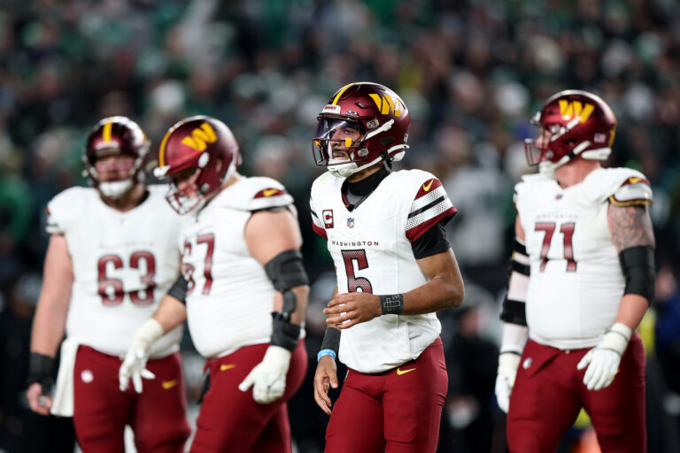 Jayden Daniels #5 of the Washington Commanders runs off the field. (Photo by Emilee Chinn/Getty Images)