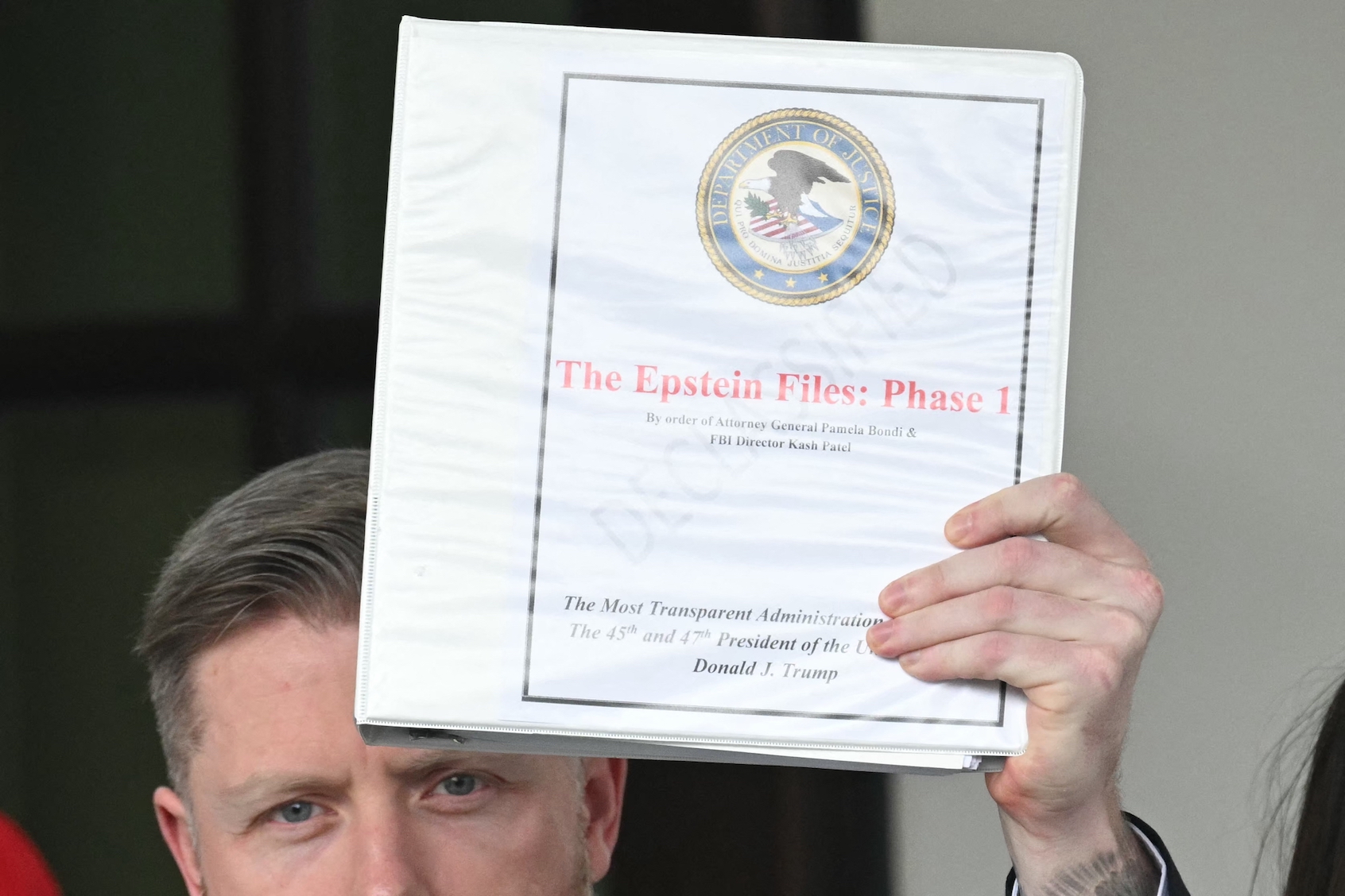 Rogan O'Handley, aka DC Draino, with a binder reading "The Epstein Files: Phase 1," leaving the White House on Feb. 27, 2025. (Saul Loeb/AFP via Getty Images)
