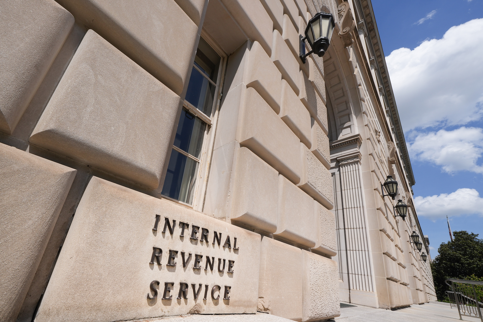 A sign marks the entrance to the Internal Revenue Service (IRS) headquarters building in Washington, DC. (Photo by J. David Ake/Getty Images)