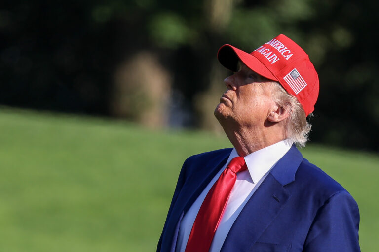 U.S. President Donald Trump looks up at the new flag on the south lawn of the White House. (Photo by Tasos Katopodis/Getty Images)