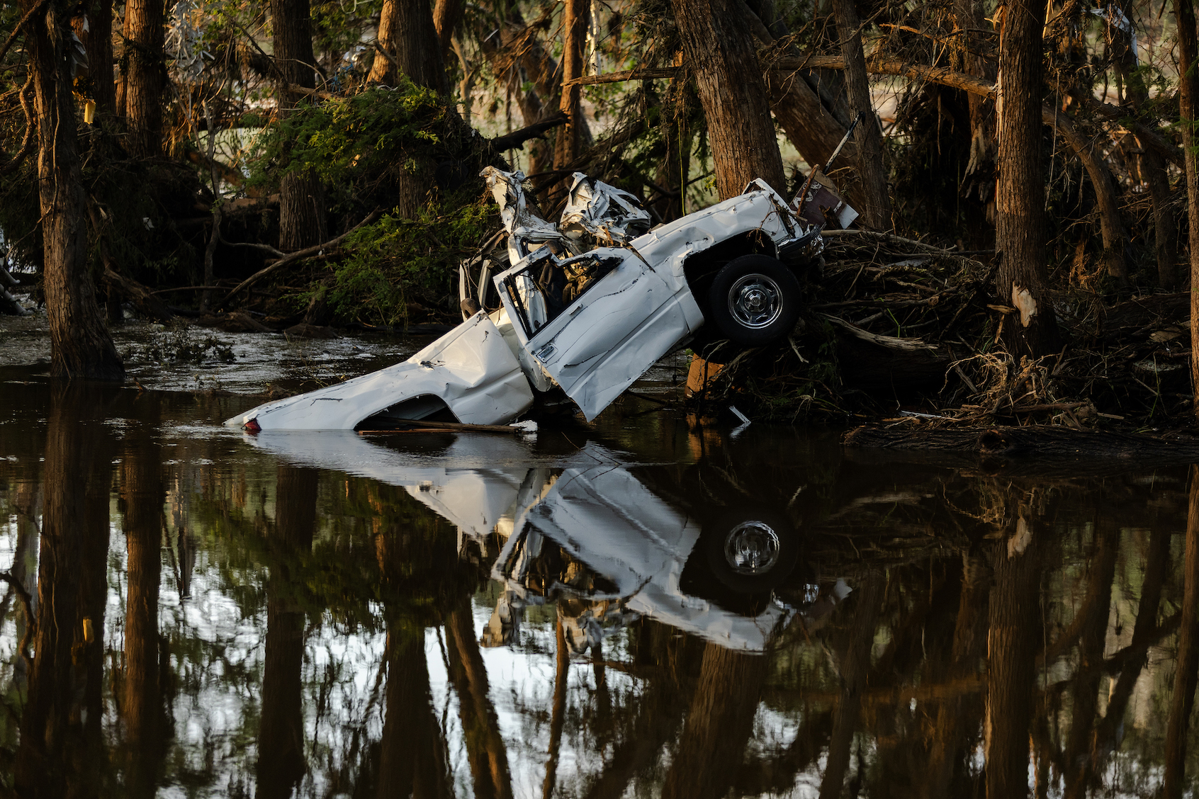 Debris lays along the Guadalupe River after it was swept up in the flash flooding on July 8, 2025 in Ingram, Texas. (Photo by Jim Vondruska/Getty Images)