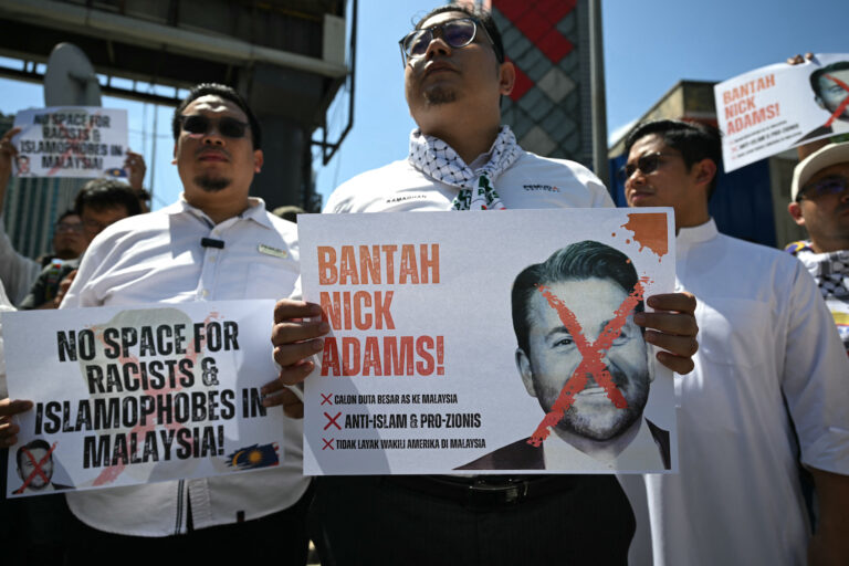 Malaysian protesters display placards during a demonstration against the US envoy nominee Nick Adams outside the US embassy in Kuala Lumpur on July 18, 2025 (Photo by Mohd Rasfan/Getty Images)