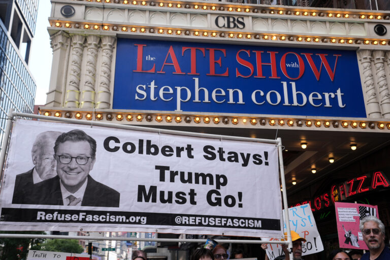 Dozens of anti-Trump protesters gathered outside the Ed Sullivan Theater, home of The Late Show with Stephen Colbert, to protest CBS's reported decision to fire the longtime host. (Photo by Lokman Vural Elibol/Getty Images)