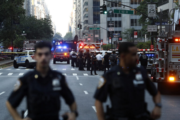 Police officers and emergency vehicles are seen in a street as police respond to a shooting incident in the Midtown Manhattan neighborhood of New York on July 28, 2025. (Photo by John Lamparski/Getty Images)
