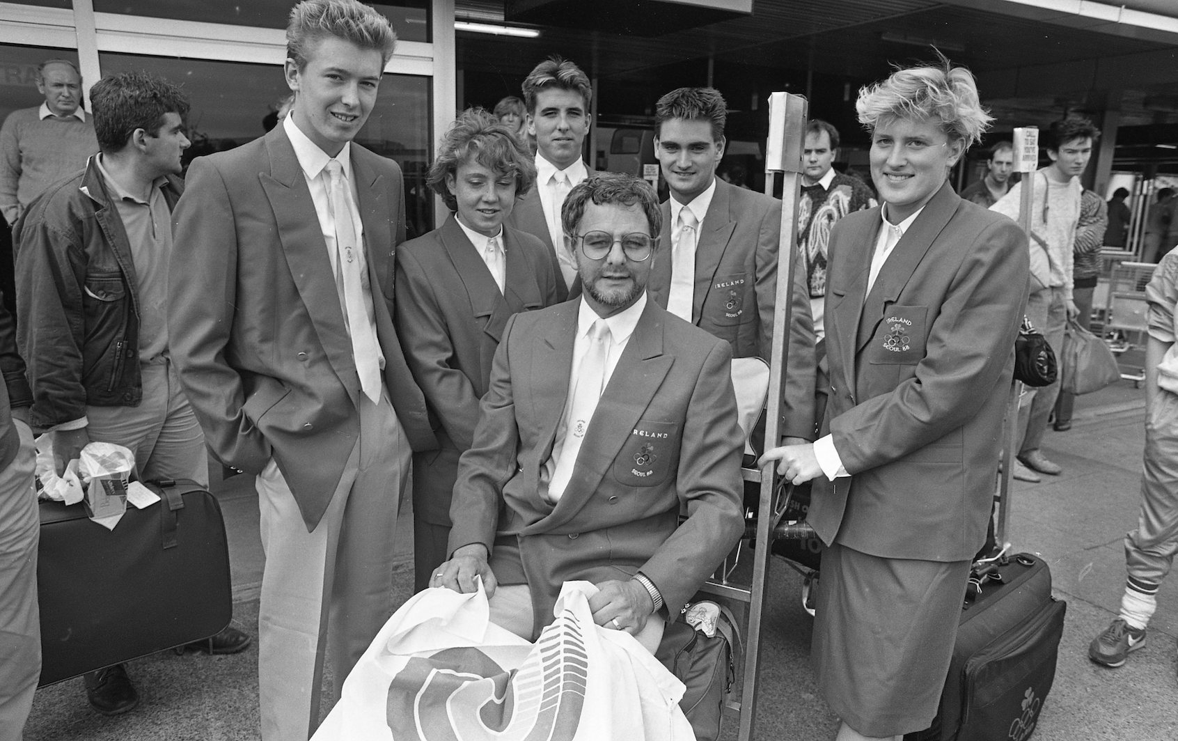 Coach George Gibney, seated in center, with members of the Irish Olympic swimming team returning from the Seoul Olympics in South Korea, Oct. 8, 1988. (Independent News and Media/Getty Images)