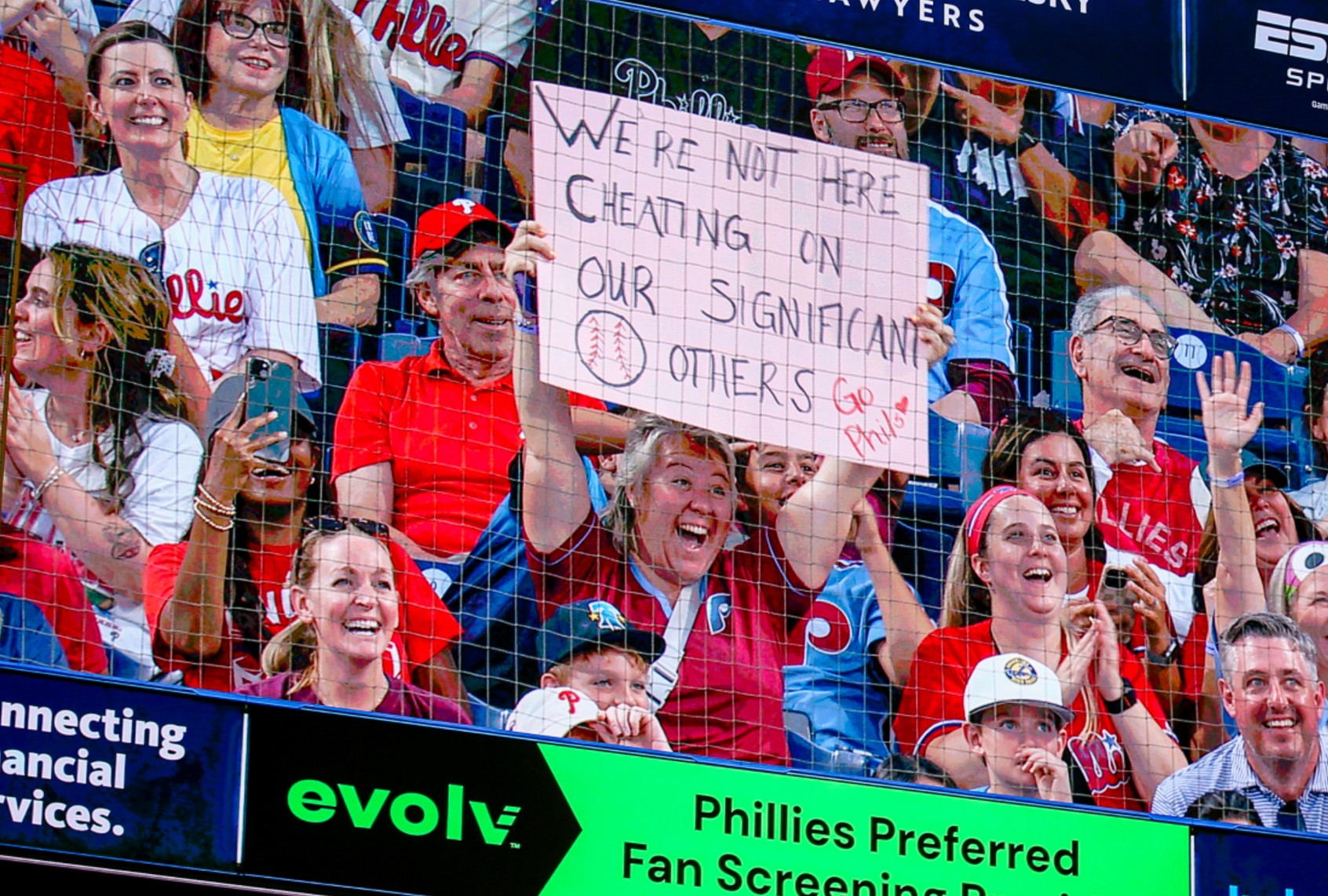 A fan holds up a sign during a kiss cam segment in the game between the Philadelphia Phillies and the Los Angeles Angels at Citizens Bank Park on July 18, 2025 in Philadelphia, Pennsylvania. (Isaiah Vazquez/Getty Images)