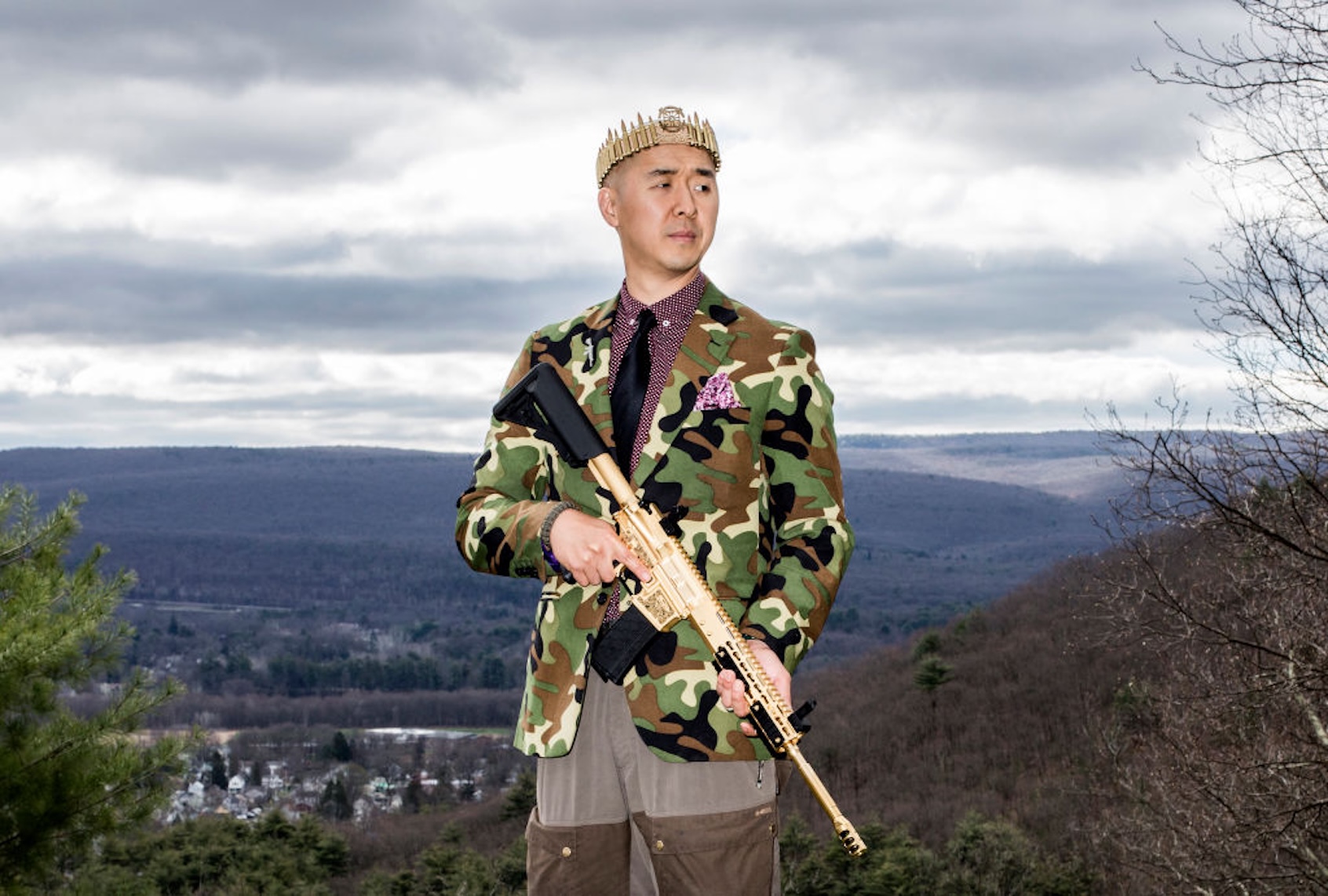 Reverend Hyung Jin "Sean" Moon poses for a portrait with his gold AR-15 "rod of iron." (Bryan Anselm/Redux For The Washington Post via Getty Images)