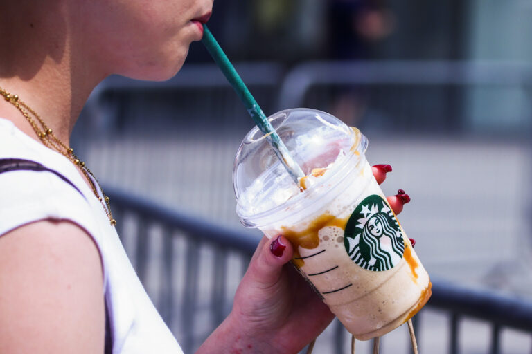 A person drinks Starbucks ice coffee in Krakow, Poland on June 7, 2025. (Beata Zawrzel/NurPhoto via Getty Image)