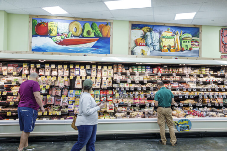 Florida, Miami Beach, Trader Joe's, grocery store supermarket food, shopping, interior, deli, cheese, cold cuts, refrigerated case, woman, man, display sale, (Jeff Greenberg / Getty Images )